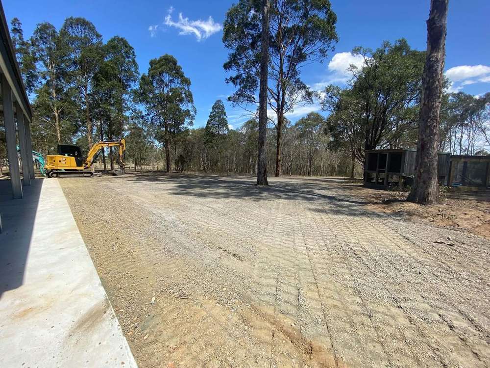 Levelled and compacted gravel hardstand beside a new shed