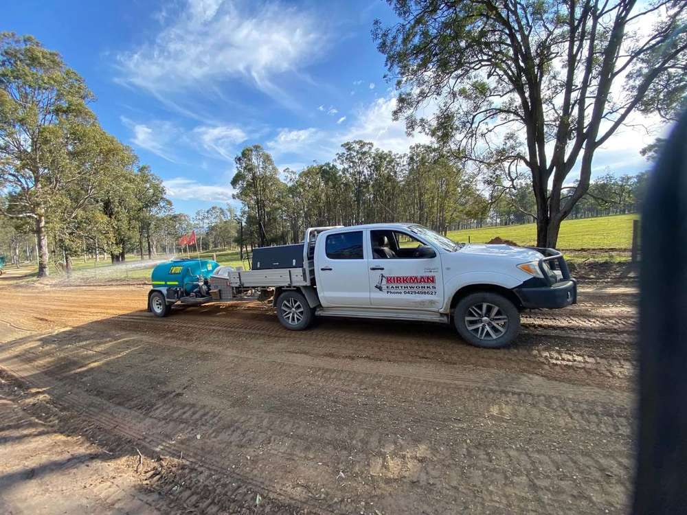 Ute and water cart on a driveway job